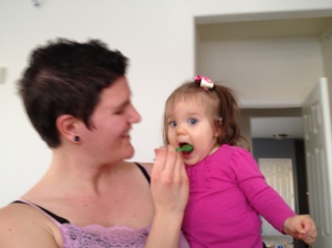 eating homemade apples and green baby food